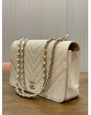 CHANEL STATEMENT FLAP BAG FEATURES IRIDESCENT BEIGE CAVIAR LEATHER CHEVRON QUILTING & LIGHT GOLD HARDWARE 