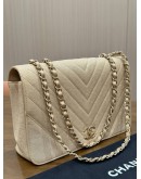 CHANEL STATEMENT FLAP BAG FEATURES IRIDESCENT BEIGE CAVIAR LEATHER CHEVRON QUILTING & LIGHT GOLD HARDWARE 